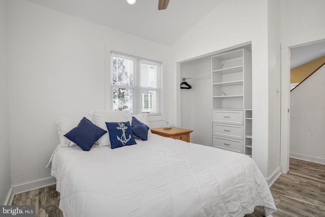 bedroom featuring hardwood / wood-style flooring, ceiling fan, and vaulted ceiling