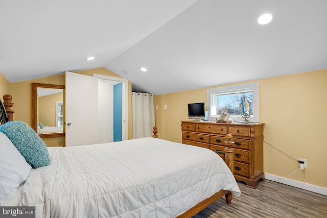 bedroom with hardwood / wood-style flooring and vaulted ceiling