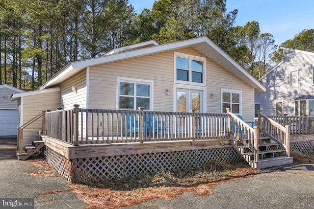 back of house featuring a wooden deck