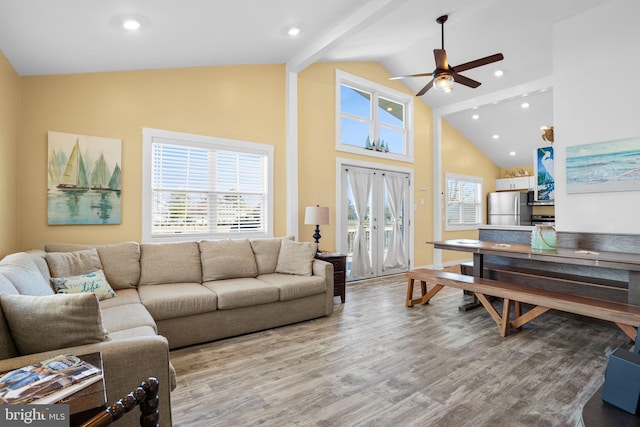 living room featuring high vaulted ceiling, wood-type flooring, ceiling fan, beam ceiling, and french doors