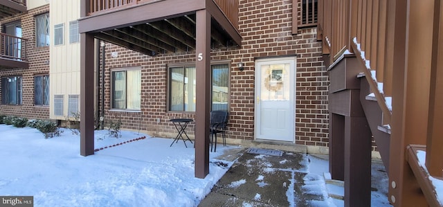 view of snow covered property entrance