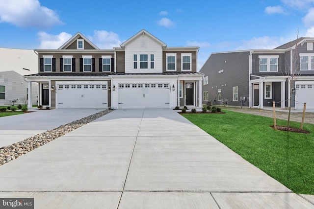 view of front of house featuring a garage and a front lawn