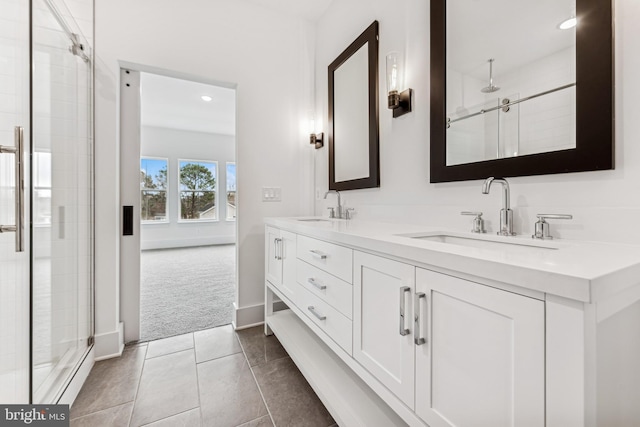 bathroom featuring a shower with door, tile patterned flooring, and vanity