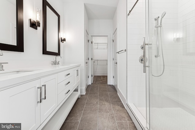 bathroom with vanity, a shower with shower door, and tile patterned floors