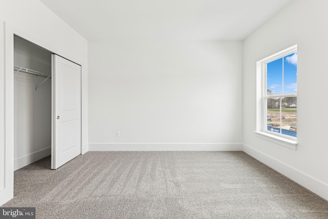 unfurnished bedroom with carpet floors and a closet