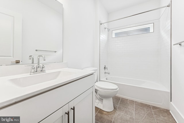 full bathroom with toilet, vanity, tiled shower / bath combo, and tile patterned flooring