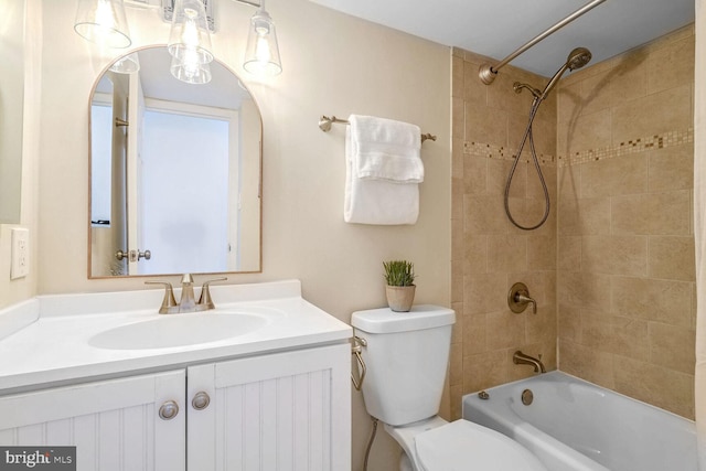 full bathroom with toilet, vanity, and tiled shower / bath