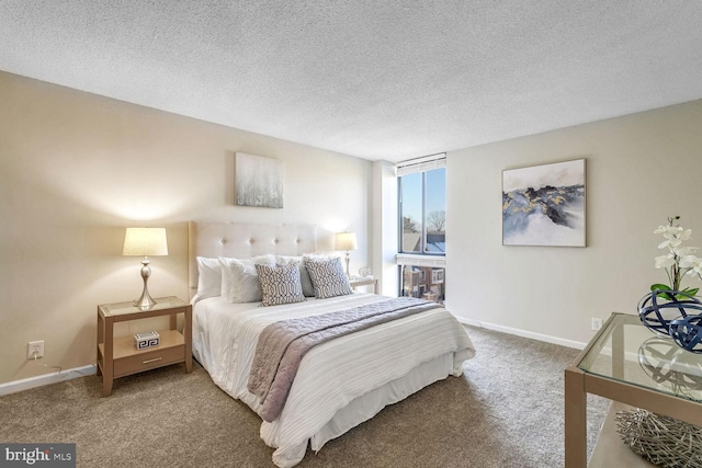 bedroom featuring carpet and a textured ceiling