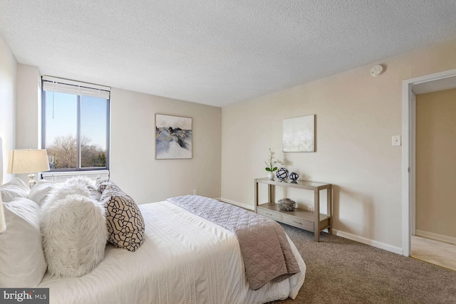 carpeted bedroom featuring a textured ceiling