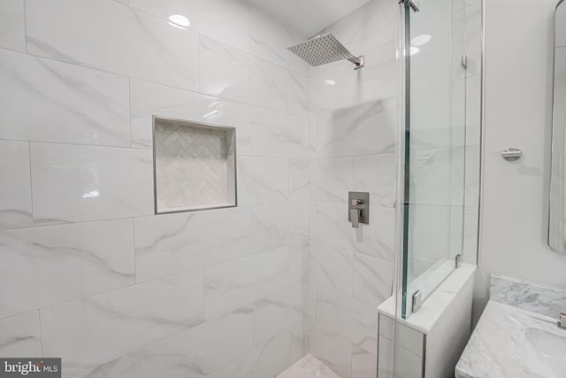 bathroom featuring vanity and a tile shower