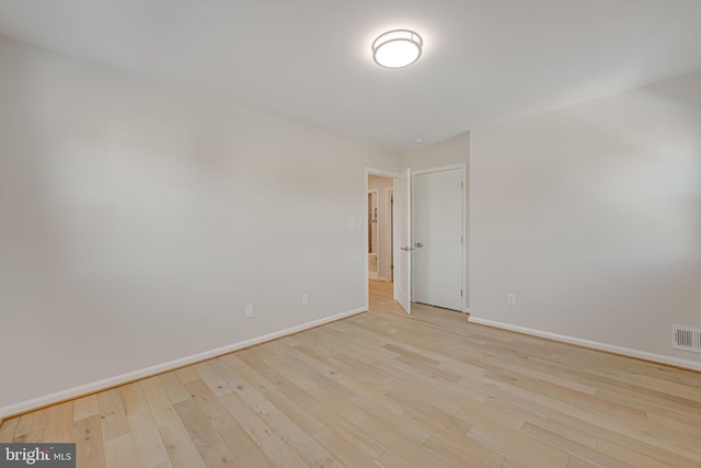 empty room with light hardwood / wood-style floors