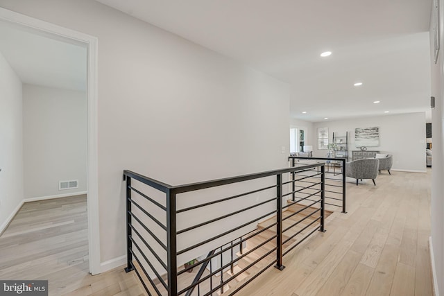 hallway with light hardwood / wood-style floors