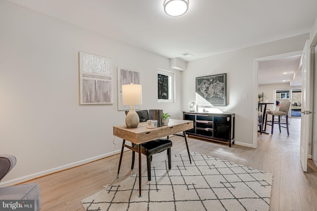 office space with light hardwood / wood-style floors