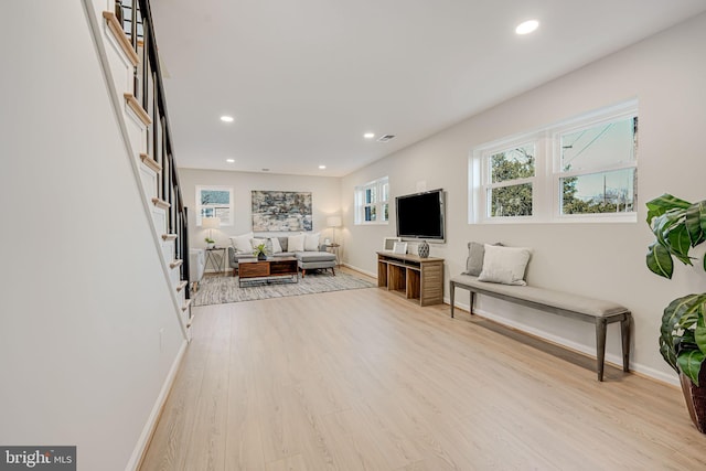 living room featuring a wealth of natural light and light hardwood / wood-style floors