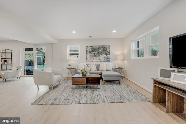 living room featuring light hardwood / wood-style flooring and a healthy amount of sunlight