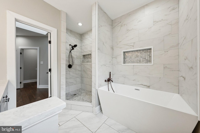 bathroom with vanity and separate shower and tub