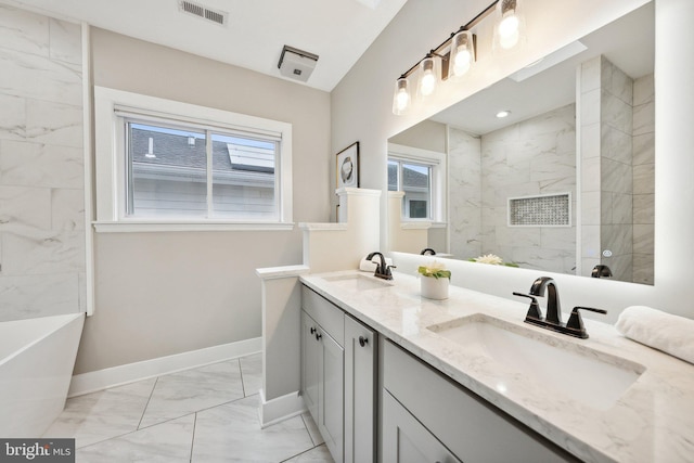 bathroom with vanity and plenty of natural light