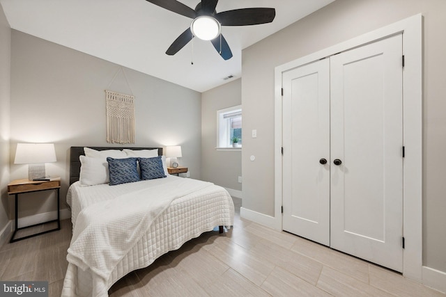 bedroom with ceiling fan, a closet, and light wood-type flooring