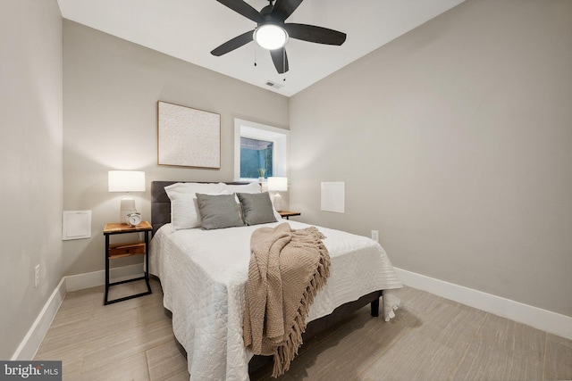 bedroom with ceiling fan and light hardwood / wood-style flooring