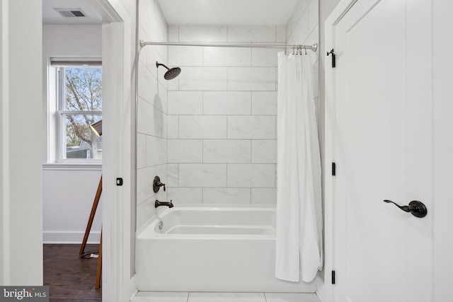 bathroom with plenty of natural light and shower / bath combo with shower curtain