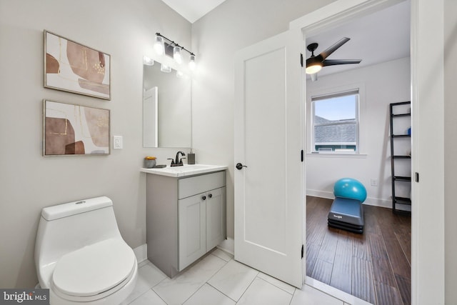 bathroom with vanity, ceiling fan, and toilet