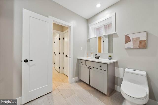 bathroom featuring vanity and toilet