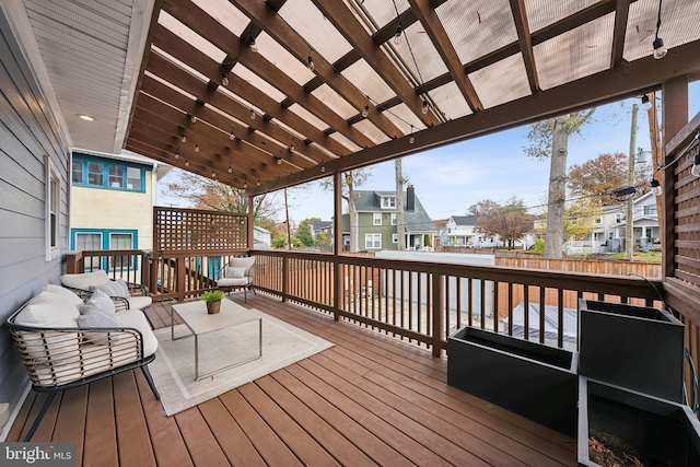 deck with an outdoor hangout area and a pergola