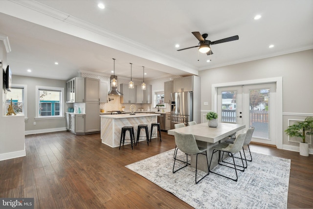 dining space featuring french doors, ceiling fan, plenty of natural light, and crown molding