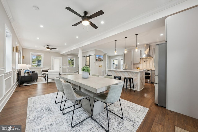 dining room featuring a wealth of natural light, ornamental molding, dark hardwood / wood-style floors, and ceiling fan