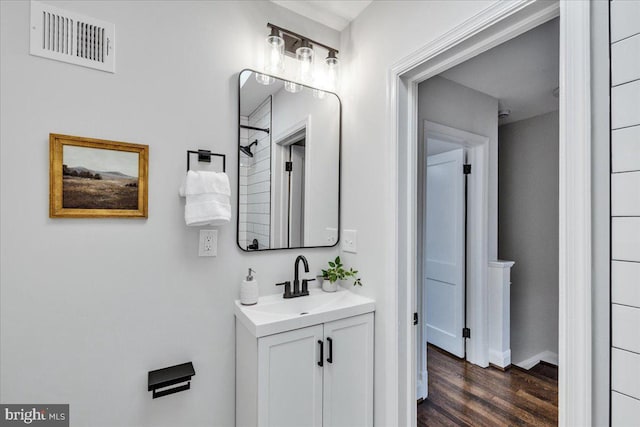 bathroom with vanity, hardwood / wood-style flooring, and a shower