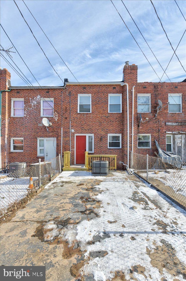 rear view of house with central AC unit