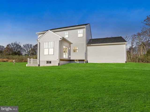 back of house with a lawn