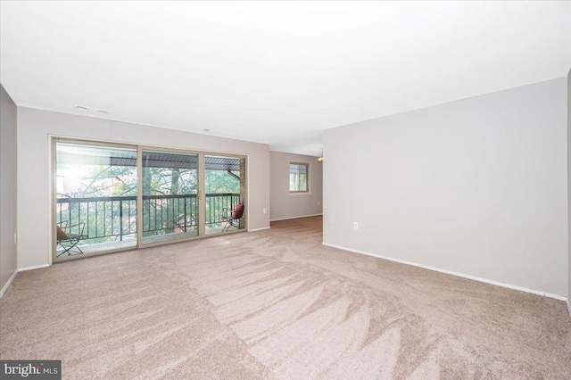 unfurnished room with light colored carpet