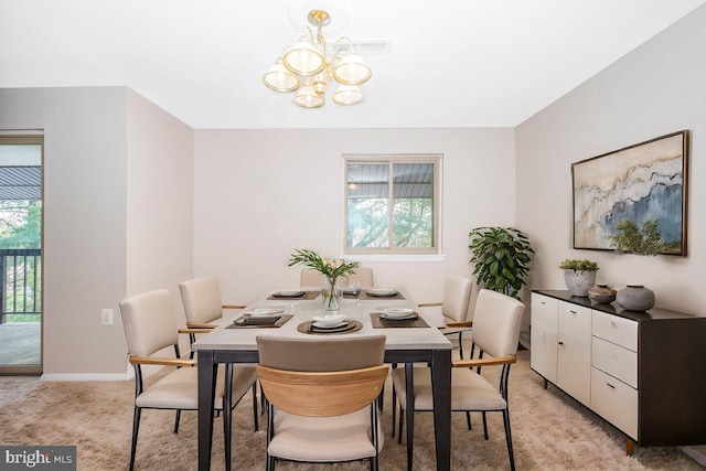 carpeted dining space with a notable chandelier