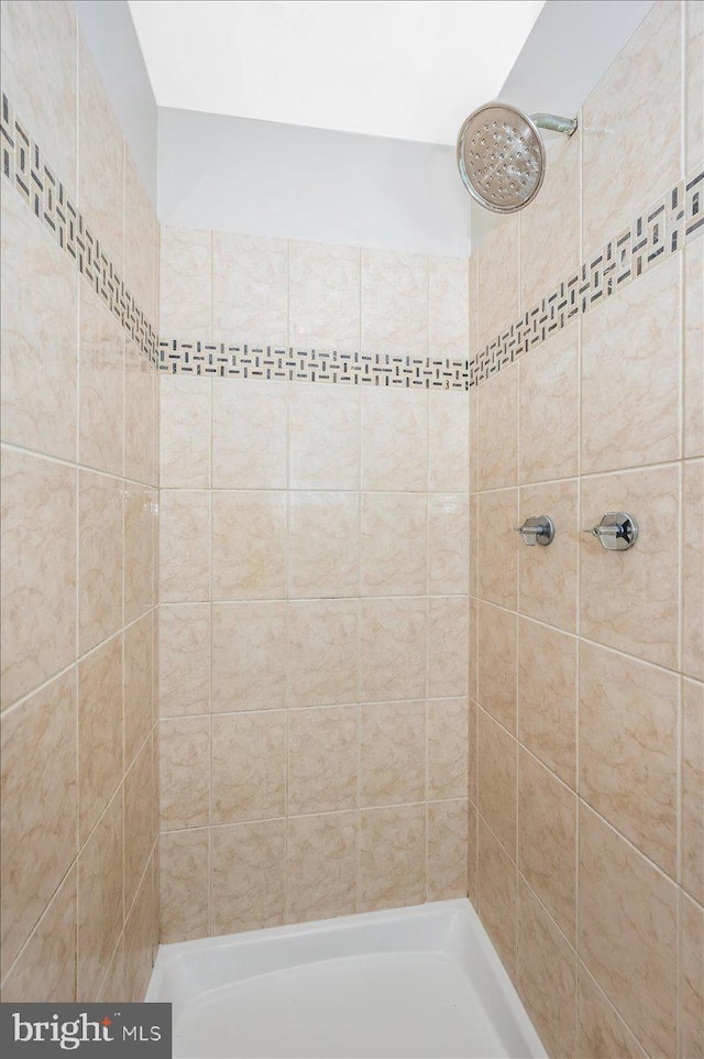 bathroom with a tile shower