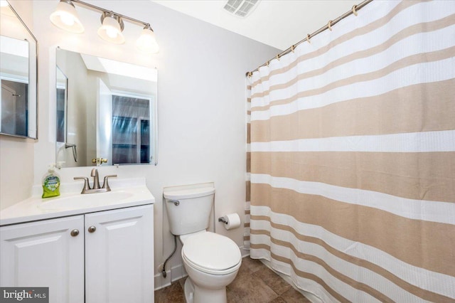 bathroom with toilet and vanity