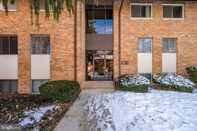 view of snow covered property entrance