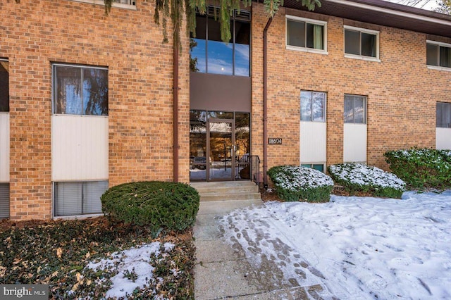 view of snow covered property entrance