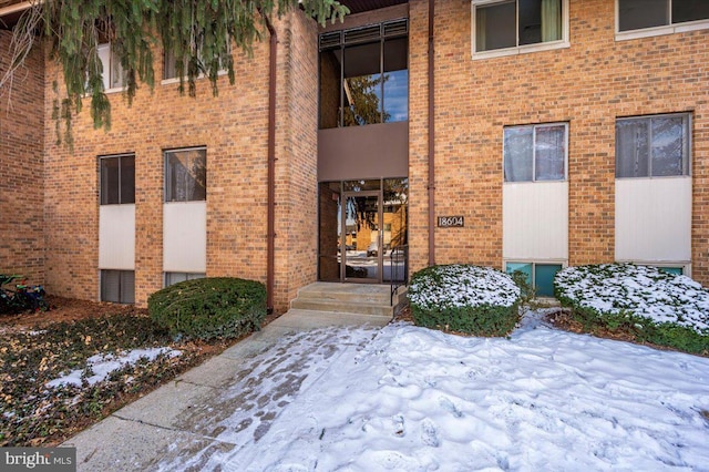 view of snow covered property entrance