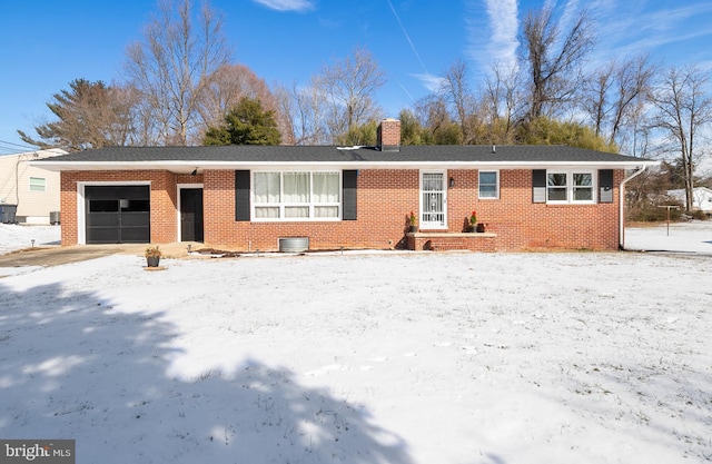 single story home with a garage and central AC unit