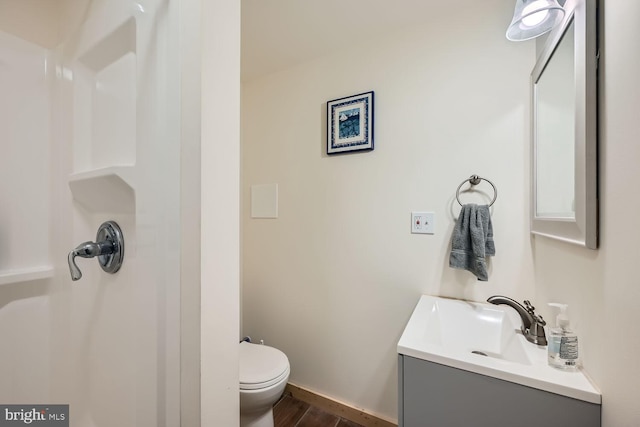 bathroom featuring vanity and toilet