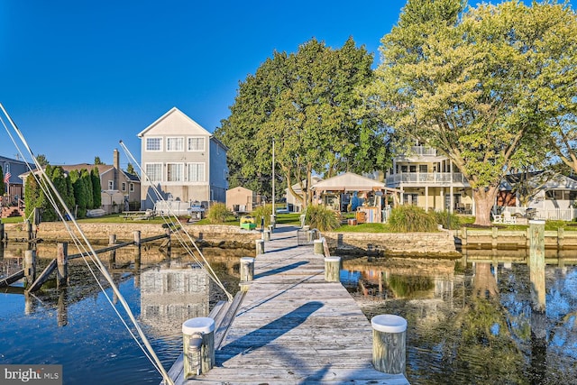 view of dock with a gazebo and a water view