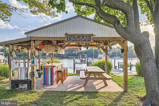 view of community with a water view and a boat dock