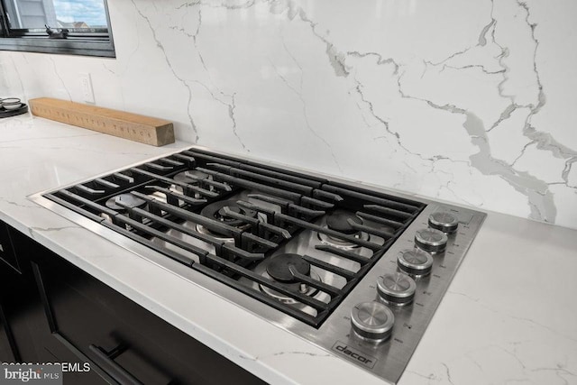 room details featuring light stone countertops and stainless steel gas cooktop