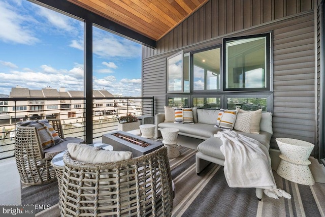 sunroom featuring wooden ceiling and lofted ceiling