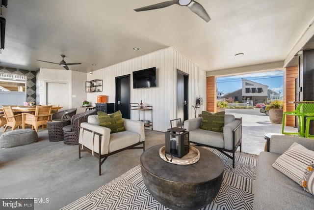 view of patio with an outdoor living space and ceiling fan