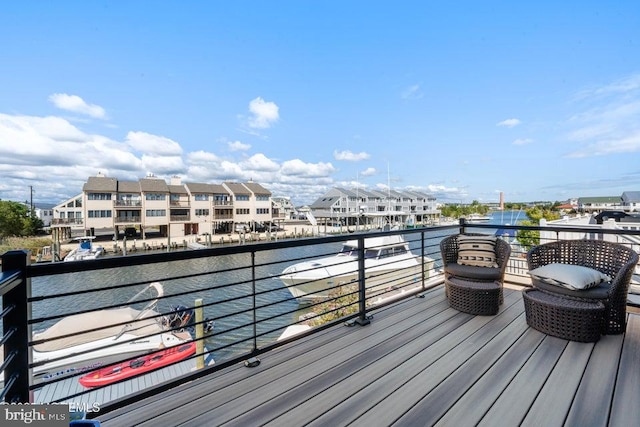 wooden terrace featuring a water view