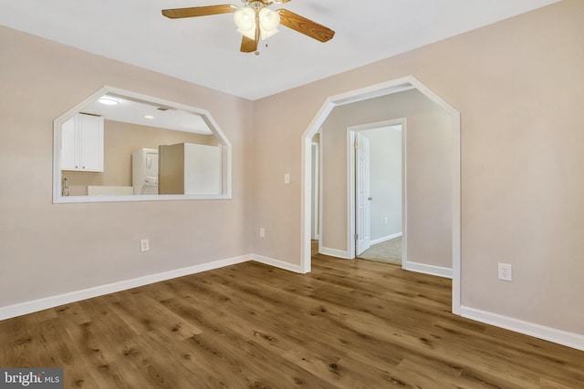 spare room featuring ceiling fan, wood-type flooring, and lofted ceiling