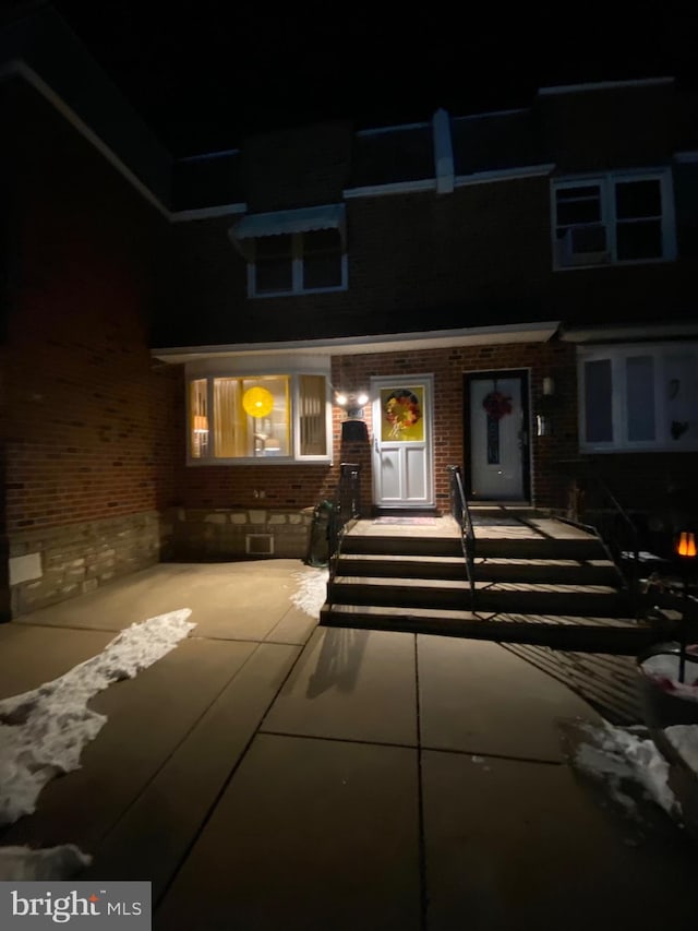 view of exterior entry at twilight