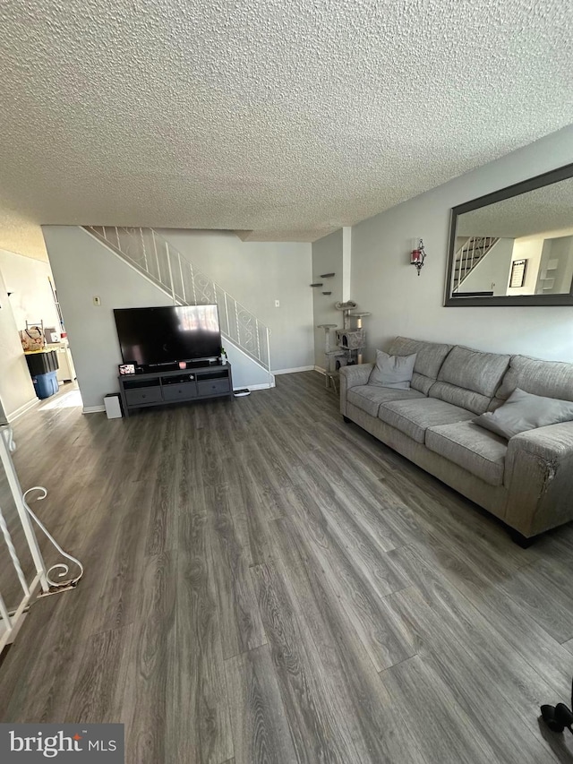 unfurnished living room with hardwood / wood-style floors and a textured ceiling